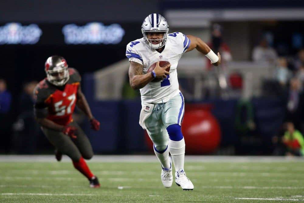 Dec 18, 2016; Arlington, TX, USA; Dallas Cowboys quarterback Dak Prescott (4) scrambles with the ball in the second quarter against the Tampa Bay Buccaneers at AT&amp;T Stadium. Mandatory Credit: Tim Heitman-USA TODAY Sports