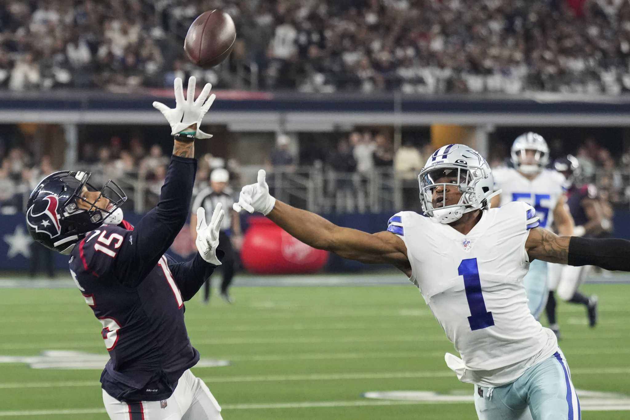 Houston Texans wide receiver Chris Moore (15) beats Dallas Cowboys cornerback Kelvin Joseph (1) for a 36-yard reception and a first down during the first half of an NFL football game Sunday, Dec. 11, 2022, in Arlington.