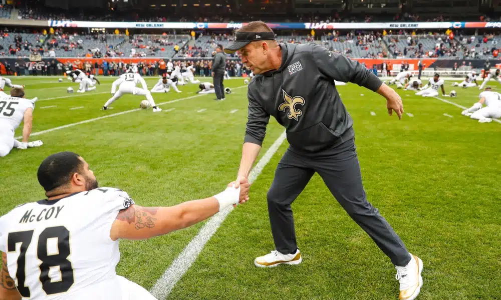 Sean Payton shaking hands with Offensive Lineman Erik McCoy