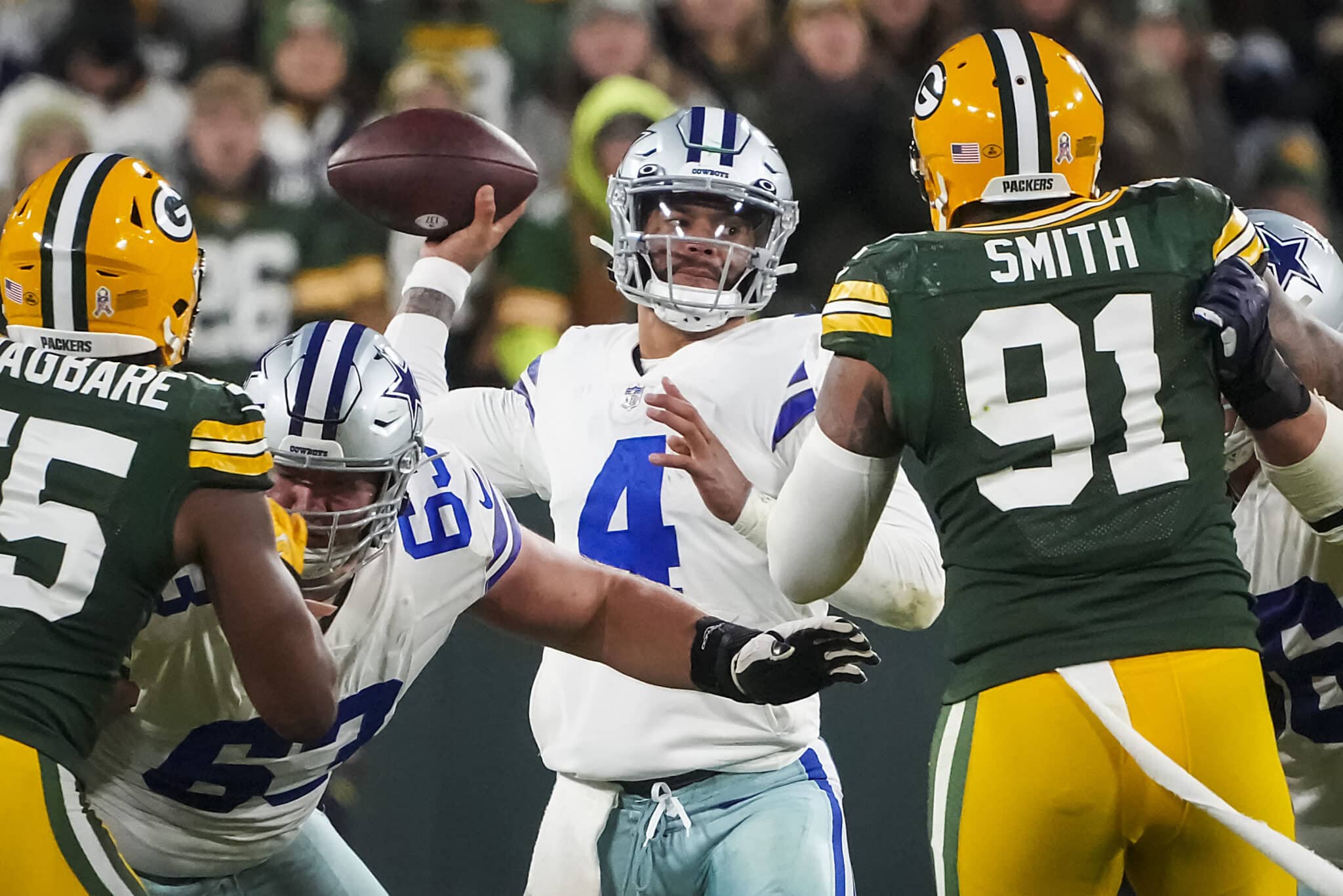 Dallas Cowboys quarterback Dak Prescott (4) throws a pass under pressure from Green Bay Packers linebacker Preston Smith (91) during the first half of an NFL football game on Sunday, Nov. 13, 2022, in Green Bay, Wisc.