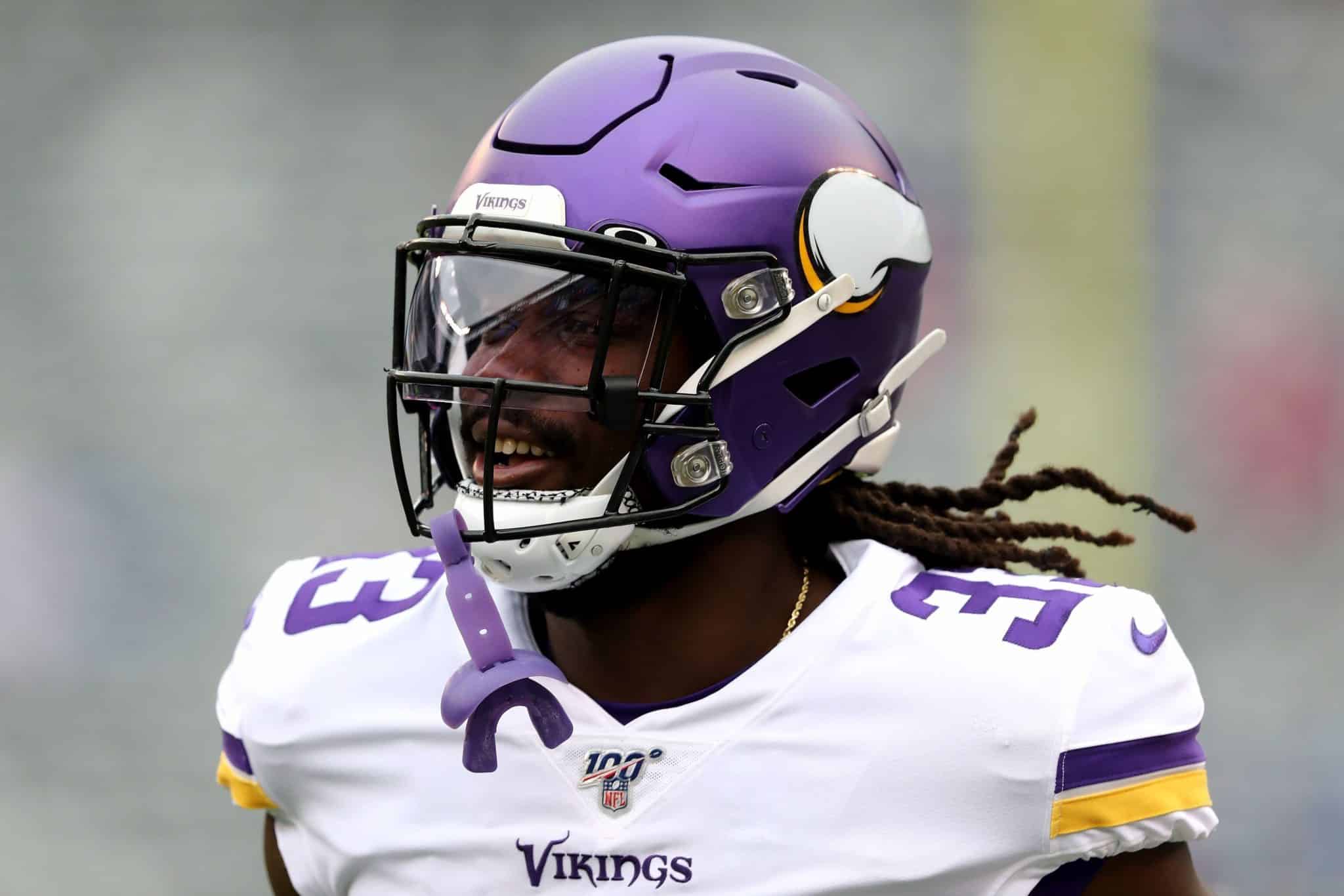 Football player wearing a purple helmet and white jersey